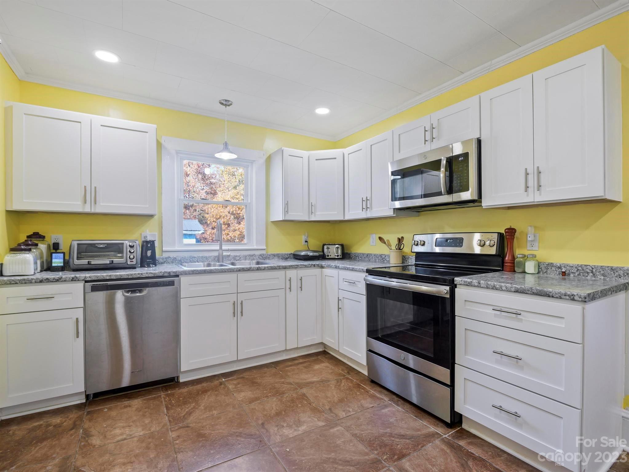979 High Shoals Church Road Mooresboro, NC 28114 - Photo 31 of 34 a kitchen with stainless steel appliances granite countertop a stove a sink and a microwave