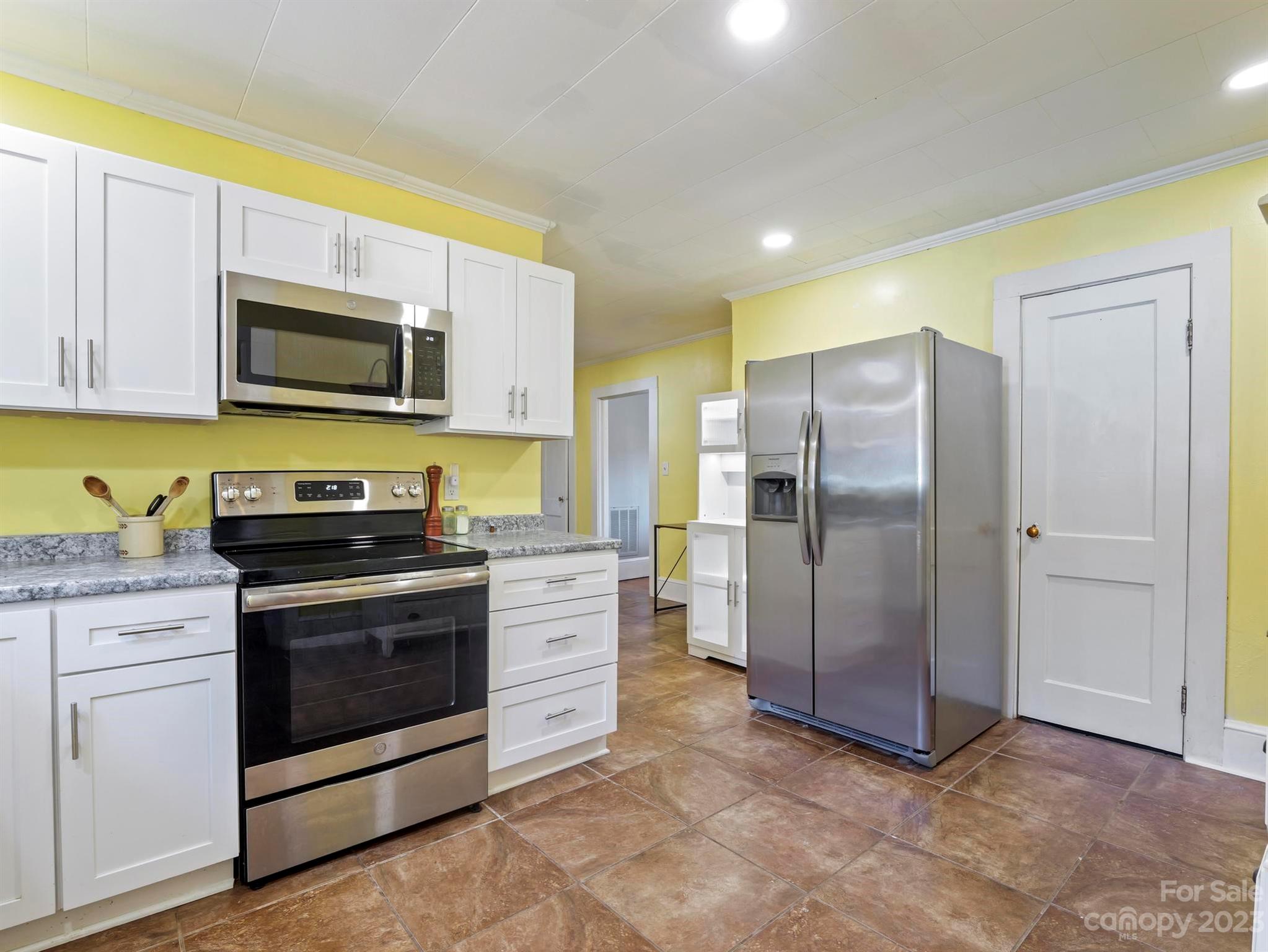 979 High Shoals Church Road Mooresboro, NC 28114 - Photo 32 of 34 a kitchen with stainless steel appliances granite countertop a stove a refrigerator and a microwave
