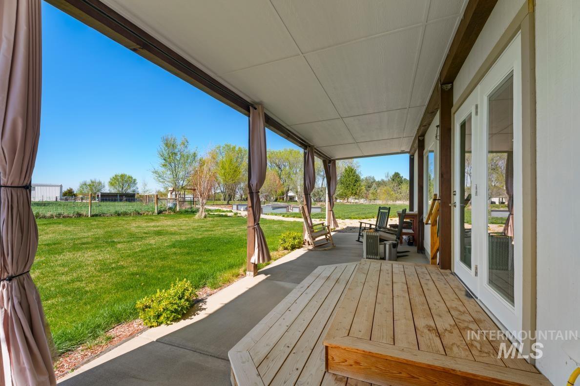 19979 Top Road Greenleaf, ID 83626 - Photo 35 of 43 Wooden porch with french doors and a lawn