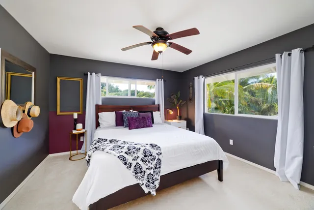 a bedroom with a large bed and a window