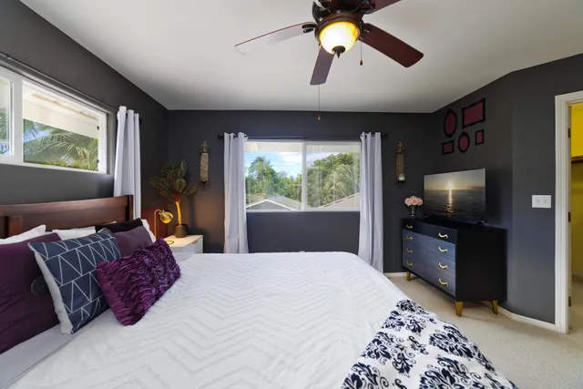 a bedroom with a large bed and flat tv screen