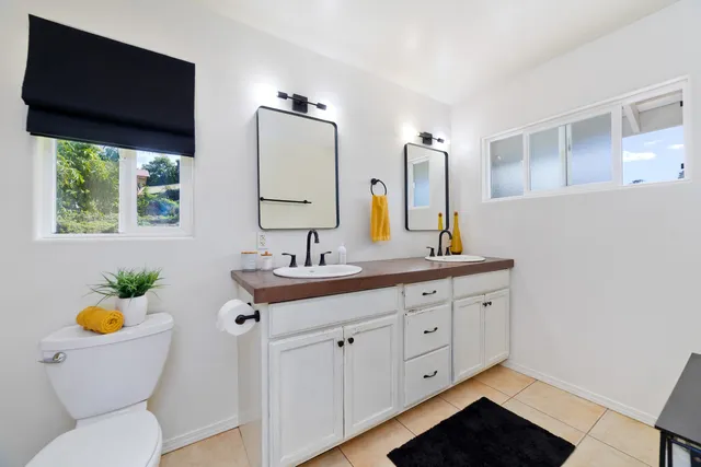 a bathroom with a toilet a sink and a mirror