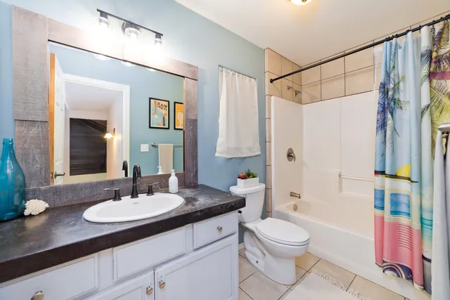 a bathroom with a sink toilet a shower and a mirror