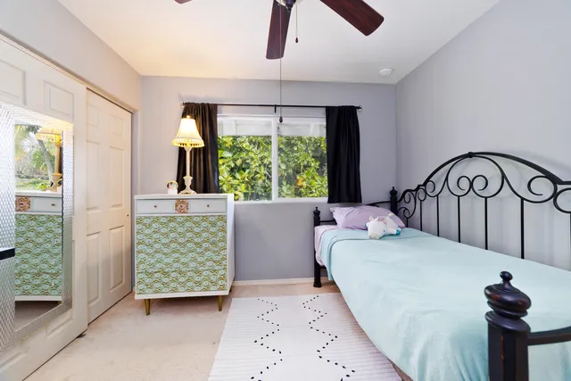 a bedroom with furniture and a large window