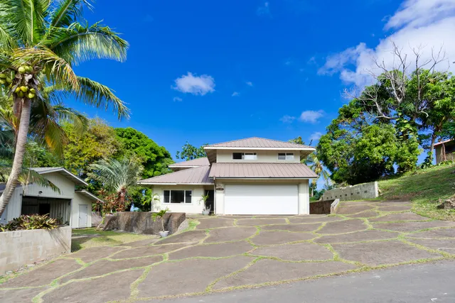 a front view of a house with garden