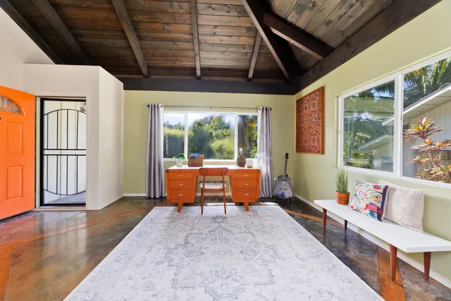 a balcony with furniture and a potted plant