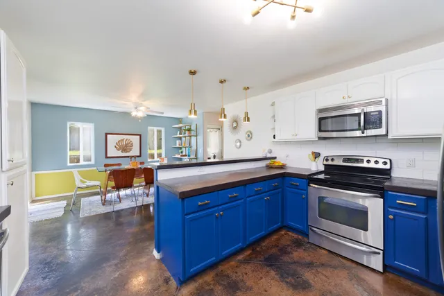 a kitchen with wooden cabinets and stainless steel appliances