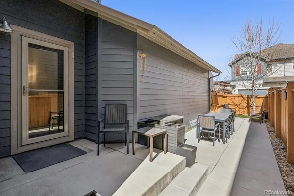 a balcony with table and chairs