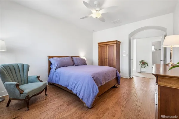 a spacious bedroom with a bed and a couch