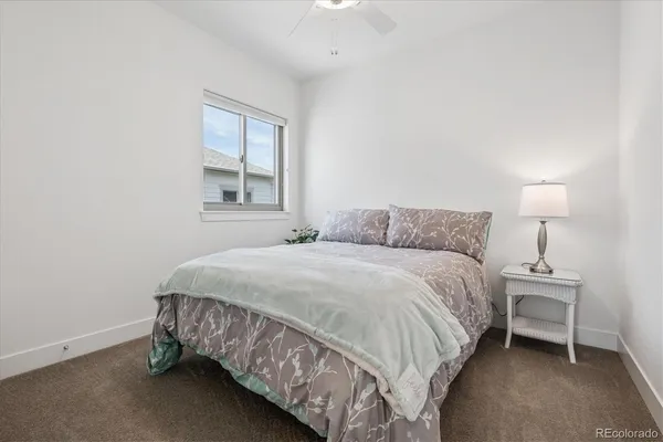 a bedroom with a bed and a lamp