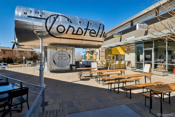 a view of a patio with table and chairs