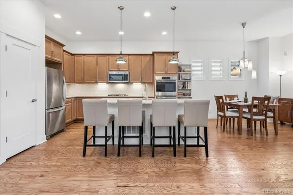 a kitchen with kitchen island a dining table and chairs