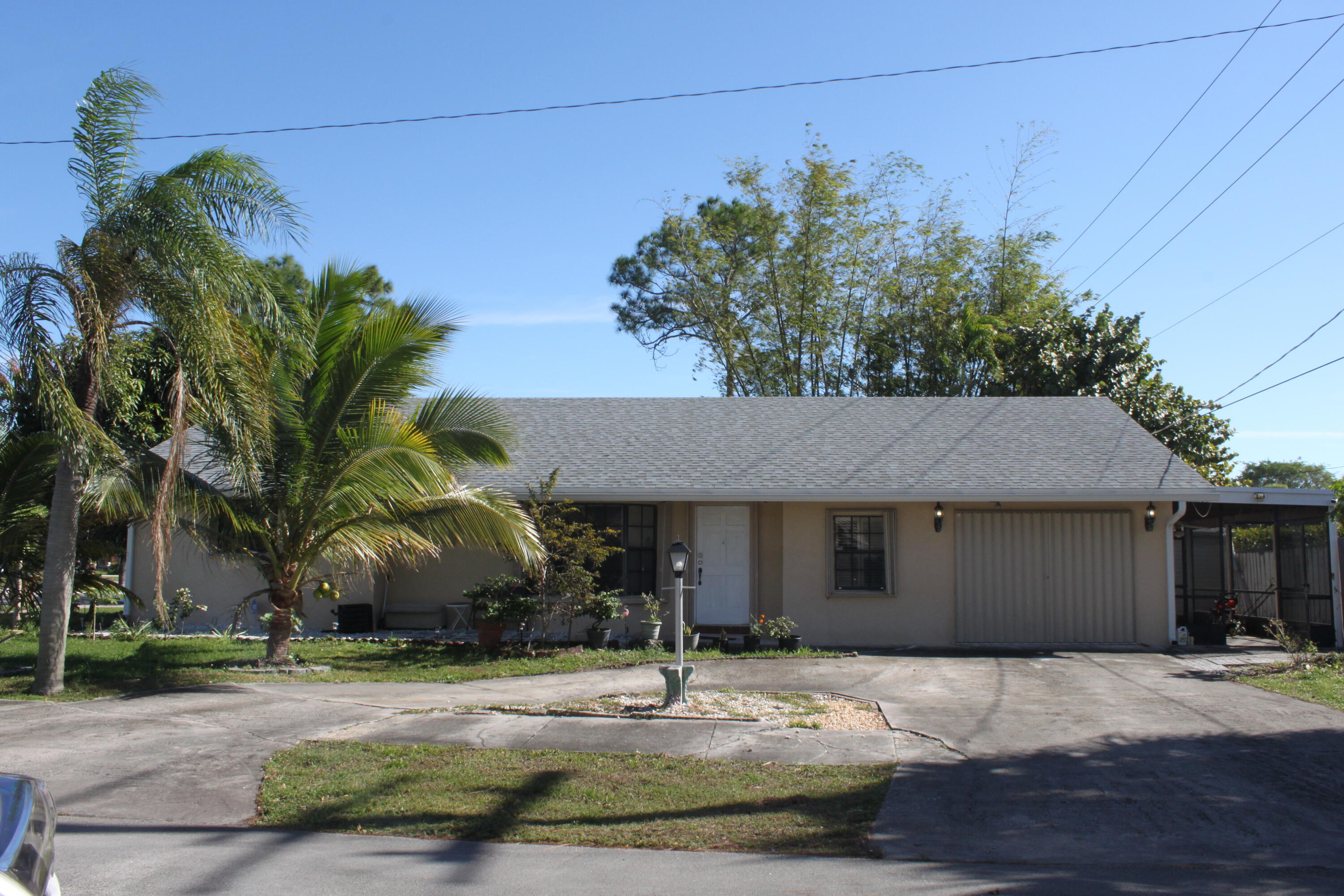 3240 Southwest 4th Street Deerfield Beach, FL 33442 - Photo 1 of 28 a house that has a tree in front of it