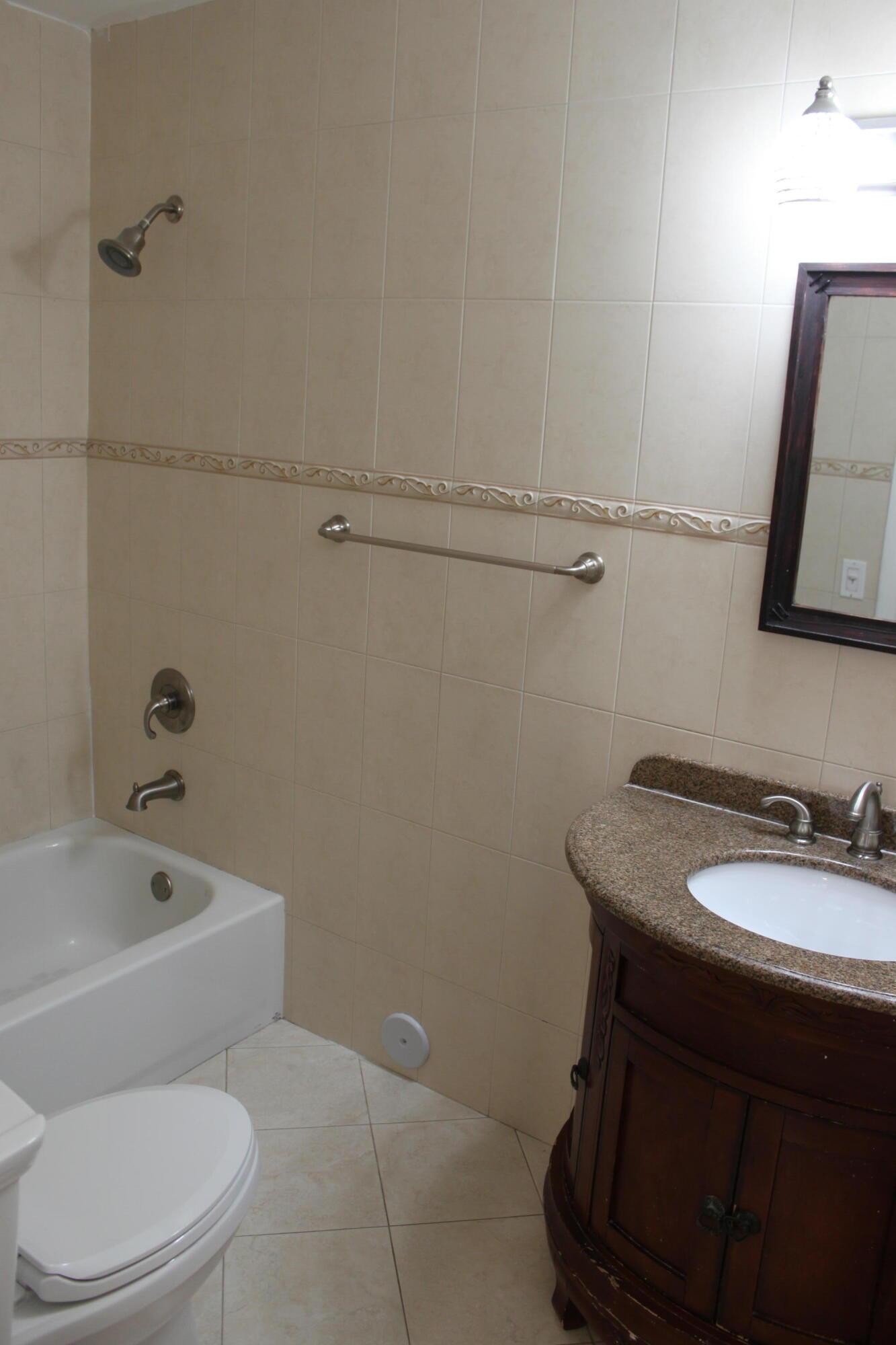 3240 Southwest 4th Street Deerfield Beach, FL 33442 - Photo 11 of 28 a bathroom with a toilet sink and mirror