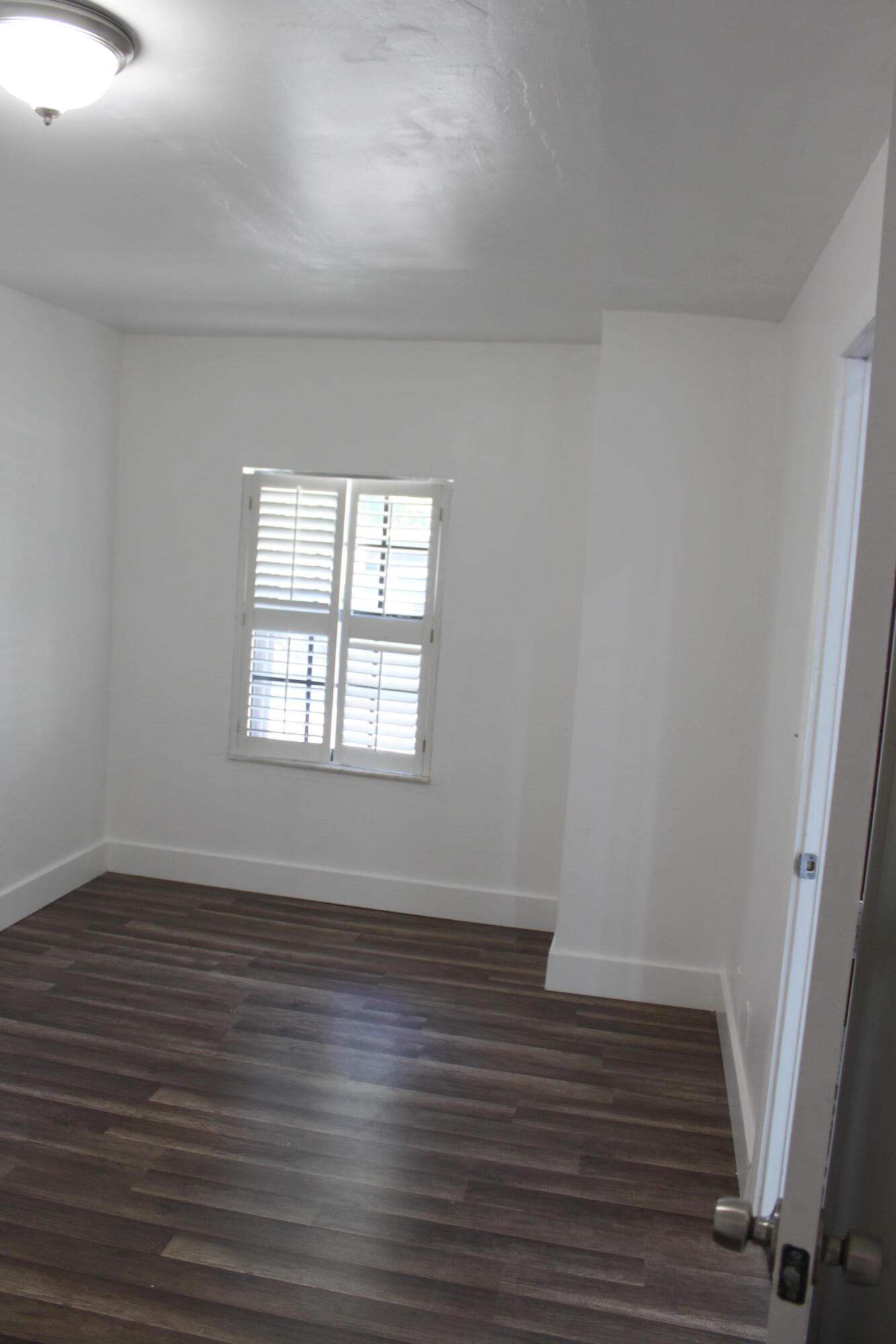 3240 Southwest 4th Street Deerfield Beach, FL 33442 - Photo 15 of 28 wooden floor in an empty room with a window