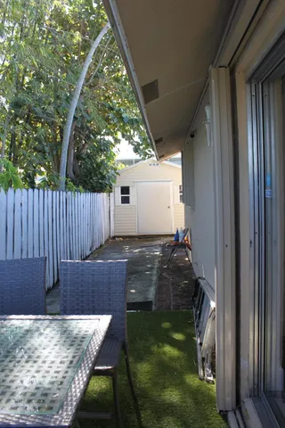 a backyard of a house with wooden fence