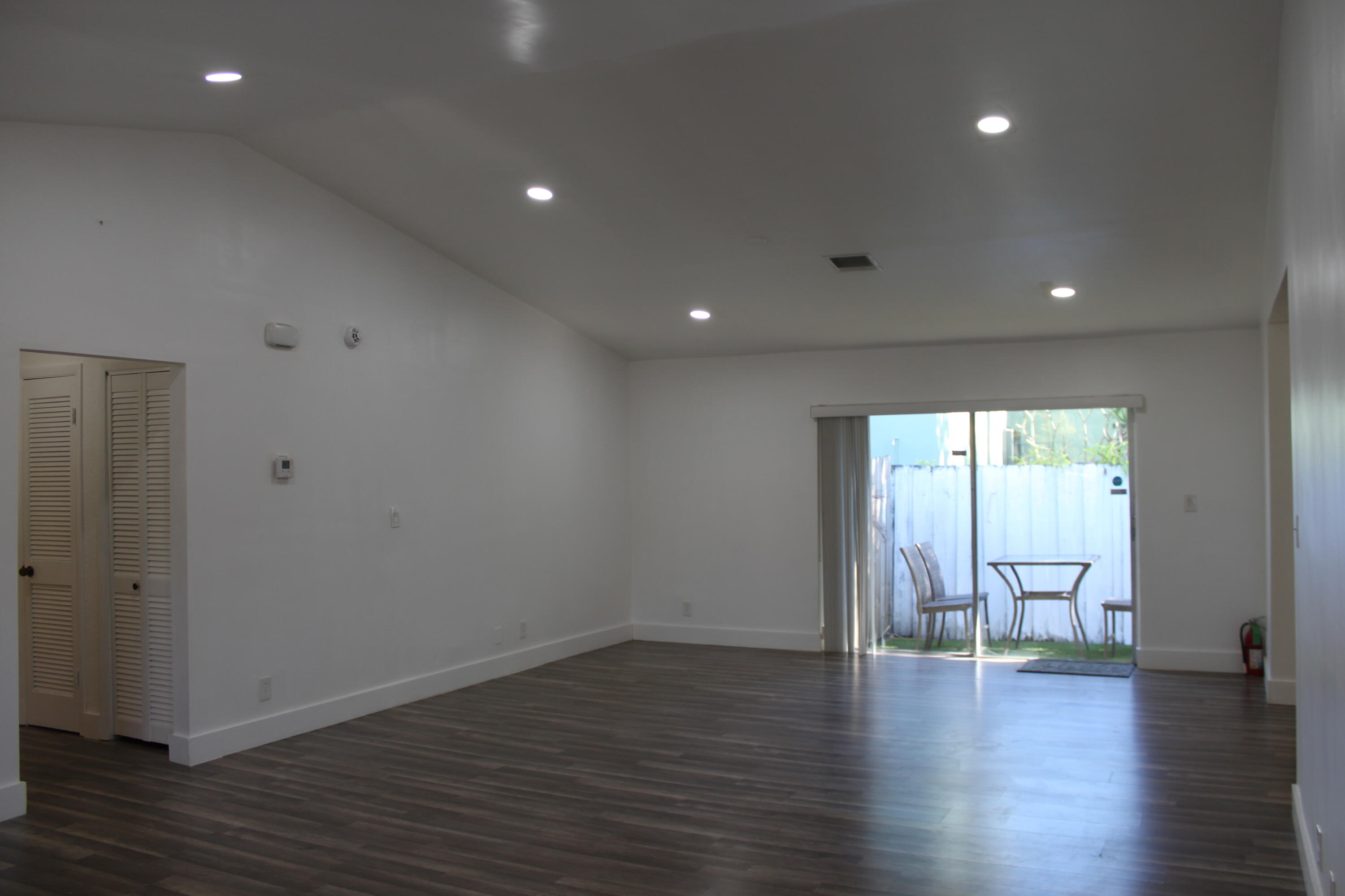 3240 Southwest 4th Street Deerfield Beach, FL 33442 - Photo 3 of 28 a view of an empty room with wooden floor and a window