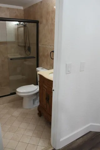 a bathroom with a toilet and a shower