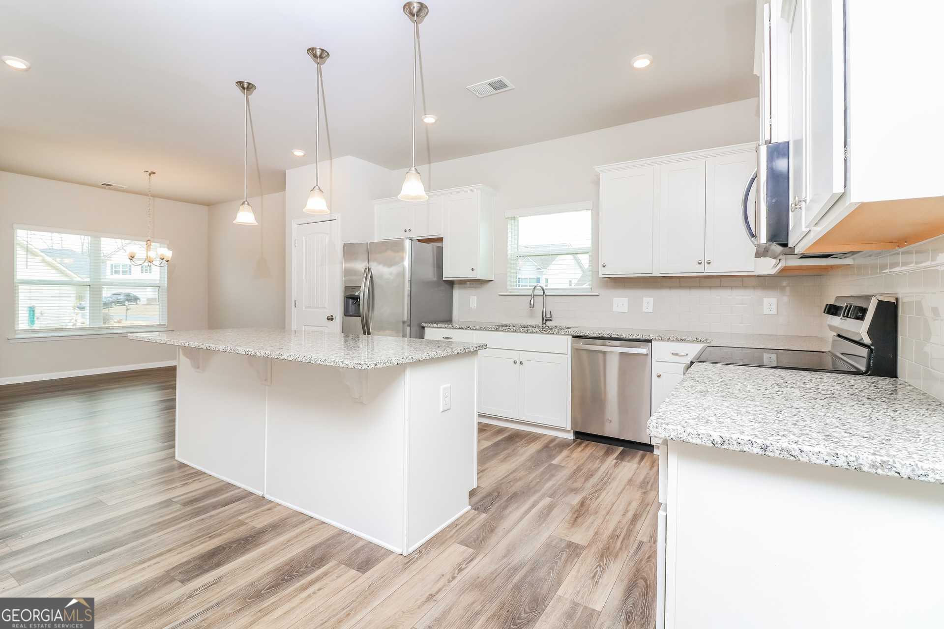 13 Applewood Drive Northeast Rome, GA 30165 - Photo 8 of 22 a open kitchen with a sink a counter top space a stove a refrigerator and a granite counter tops