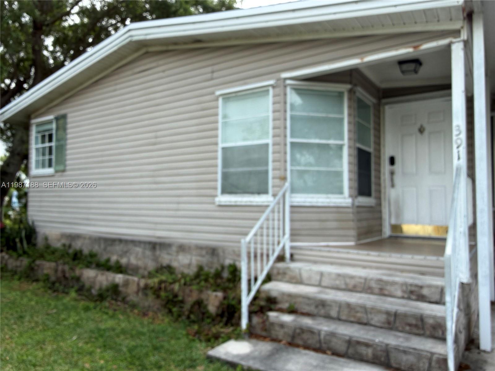 35303 Southwest 180th Avenue, Unit 391 Homestead, FL 33034 - Photo 11 of 23 a front view of a house with plants