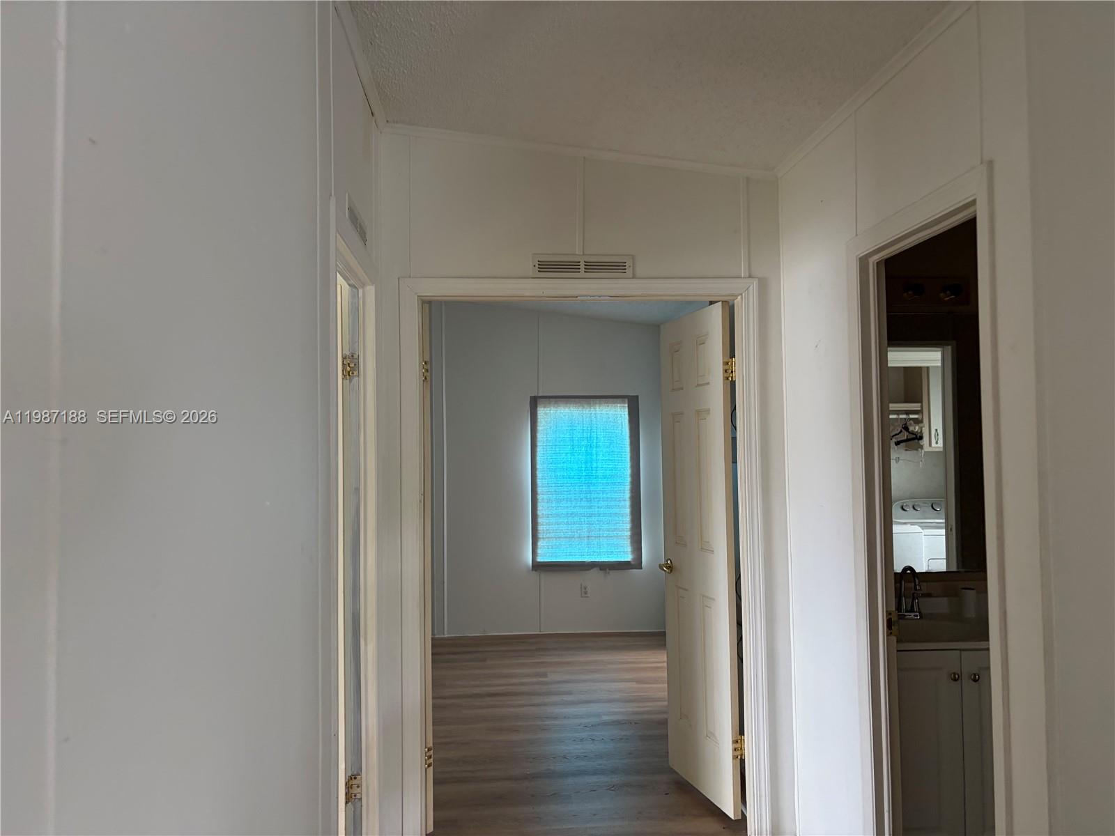 35303 Southwest 180th Avenue, Unit 391 Homestead, FL 33034 - Photo 20 of 23 a view of a hallway with wooden floor