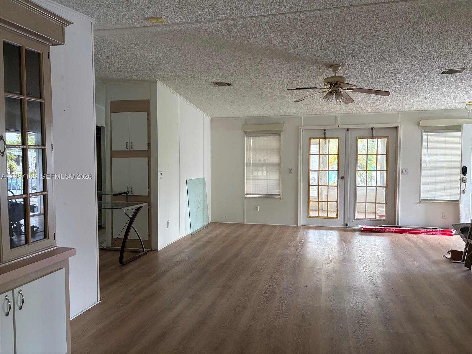 35303 Southwest 180th Avenue, Unit 391 Homestead, FL 33034 - Photo 22 of 23 a view of an empty room with a window and wooden floor