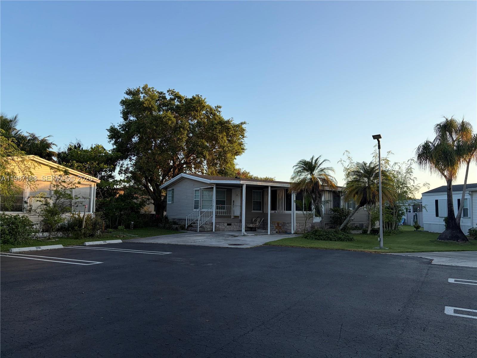 35303 Southwest 180th Avenue, Unit 391 Homestead, FL 33034 - Photo 3 of 23 a front view of house with yard and green space