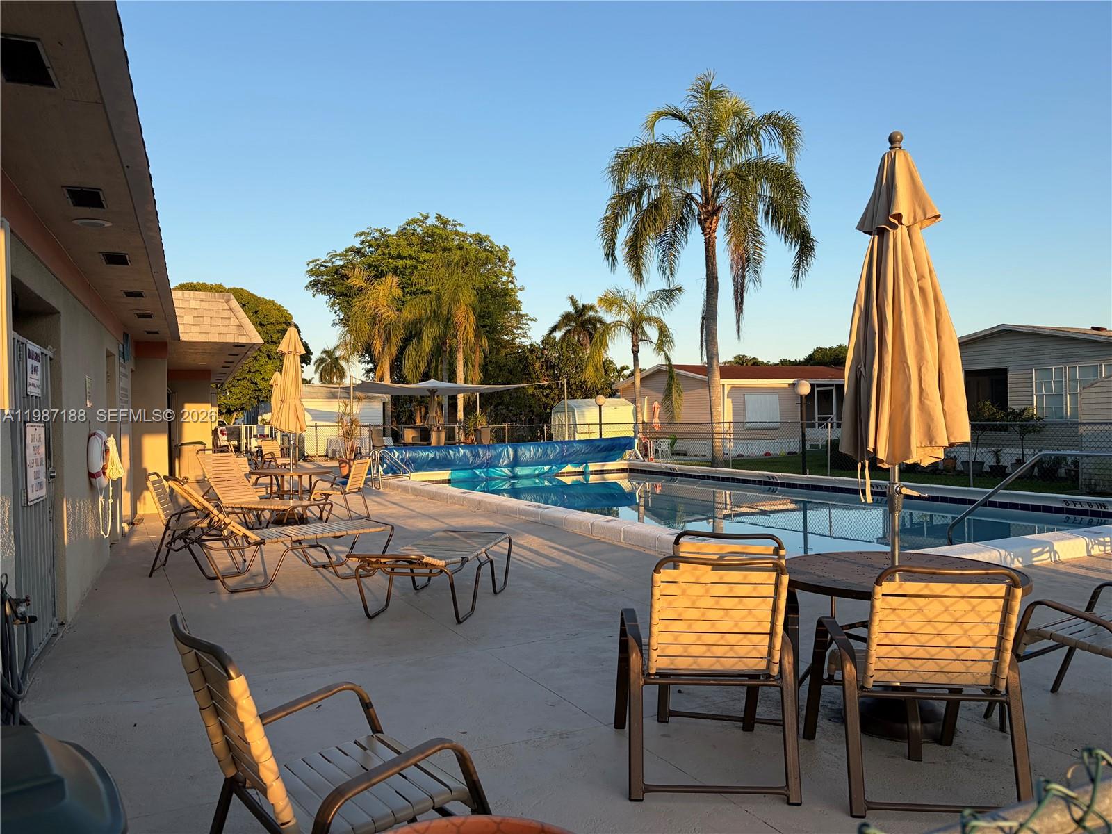 35303 Southwest 180th Avenue, Unit 391 Homestead, FL 33034 - Photo 5 of 23 a view of a chairs and table in patio