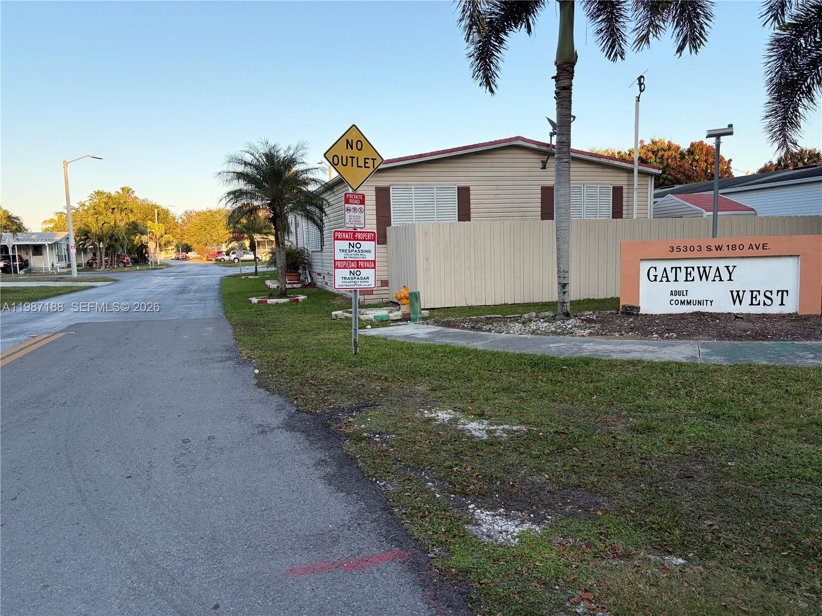 35303 Southwest 180th Avenue, Unit 391 Homestead, FL 33034 - Photo 7 of 23 a view of a white house with a yard and potted plants