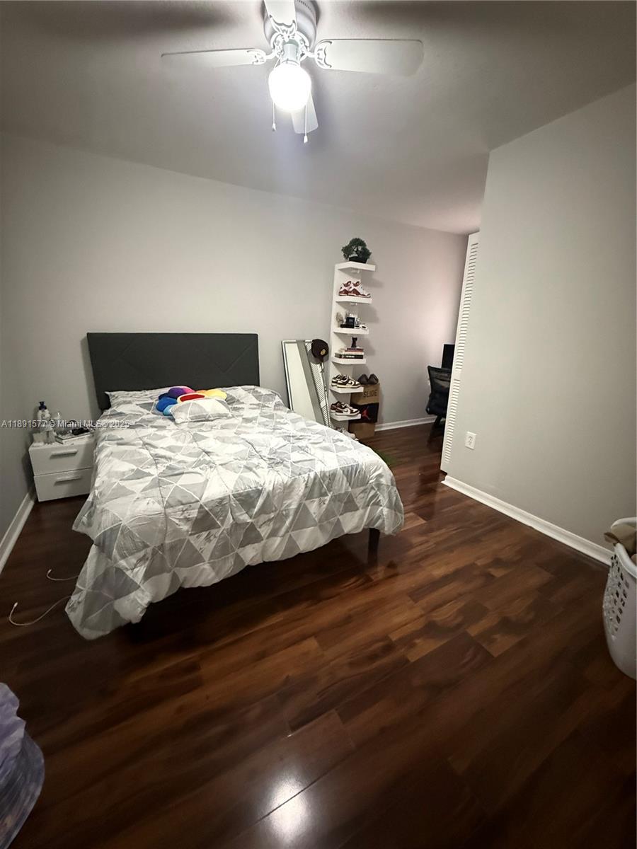 7145 Northwest 173rd Drive, Unit 1106 Hialeah, FL 33015 - Photo 15 of 17 a bedroom with a bed and wooden floor