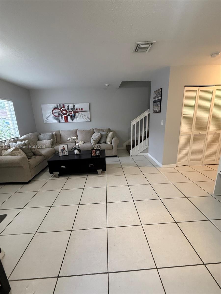 7145 Northwest 173rd Drive, Unit 1106 Hialeah, FL 33015 - Photo 2 of 17 a living room with furniture