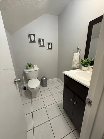 a bathroom with a sink toilet and mirror