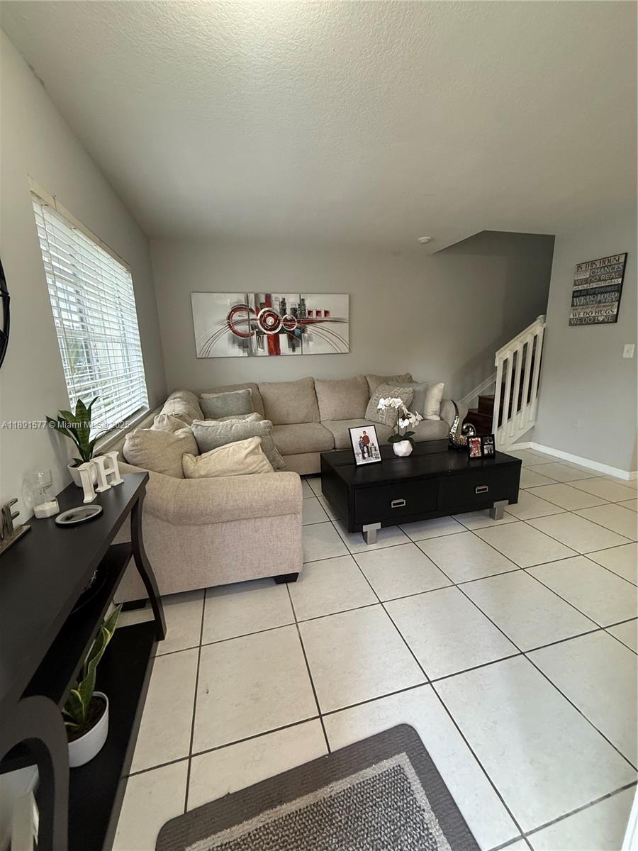 7145 Northwest 173rd Drive, Unit 1106 Hialeah, FL 33015 - Photo 6 of 17 a living room with furniture