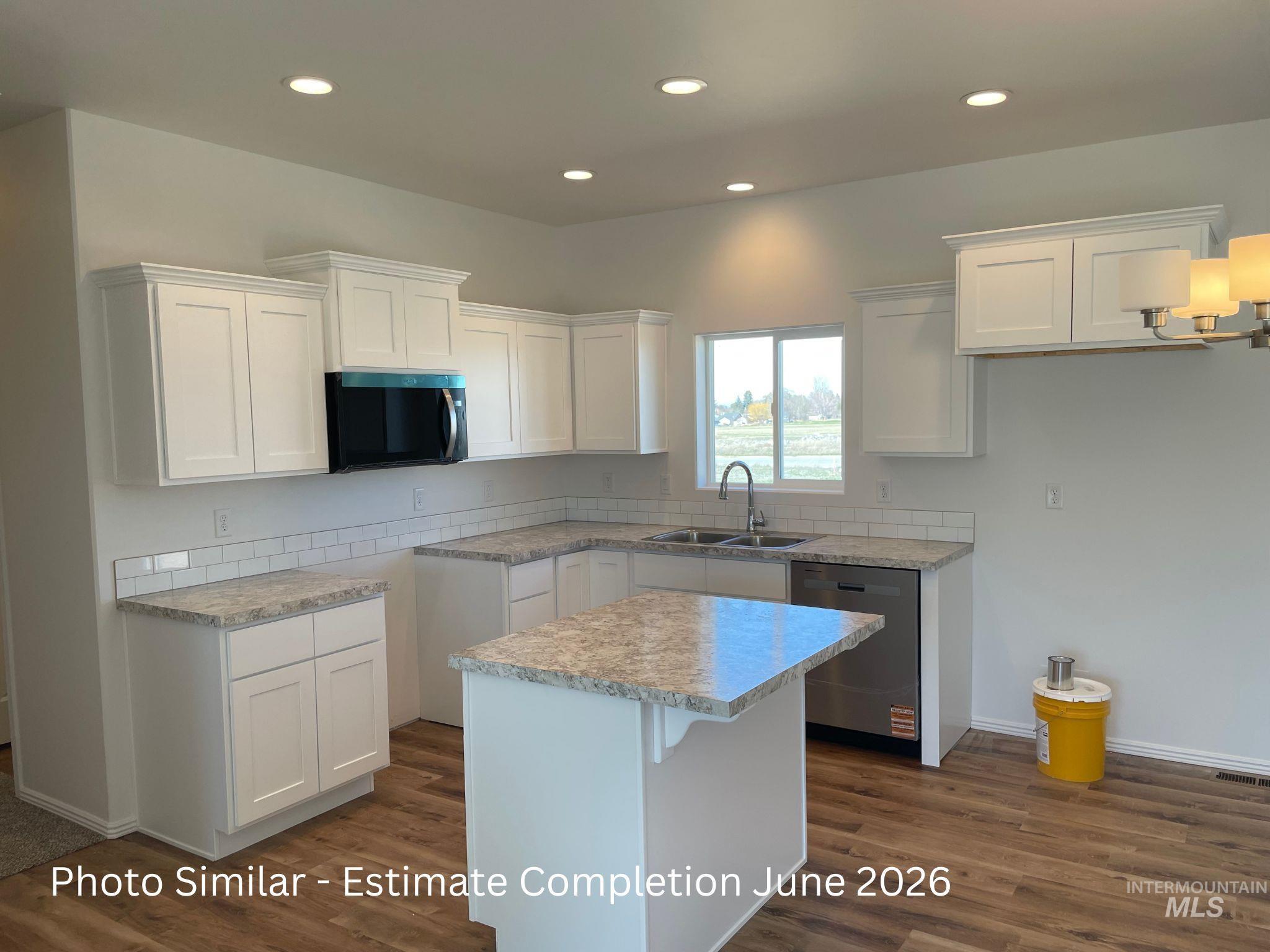 933 Roen Road Jerome, ID 83338 - Photo 2 of 2 Kitchen featuring white cabinets, light countertops, stainless steel appliances, recessed lighting, and a center island
