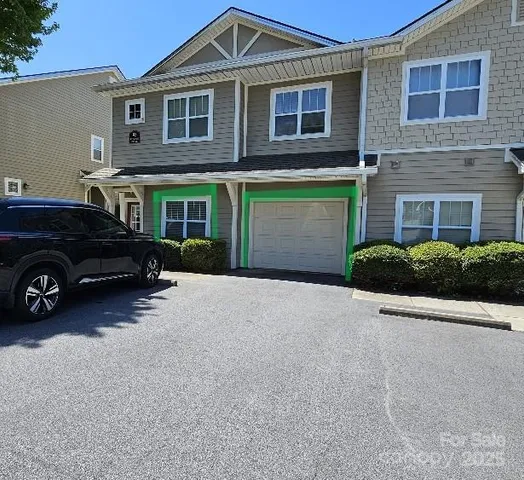 a car parked in front of a brick house