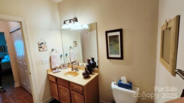 a bathroom with a sink vanity granite and a mirror