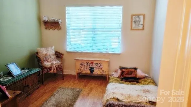 a bedroom with furniture and a wooden floor
