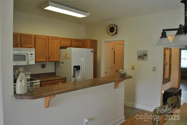 a kitchen with stainless steel appliances a refrigerator and a counter top space