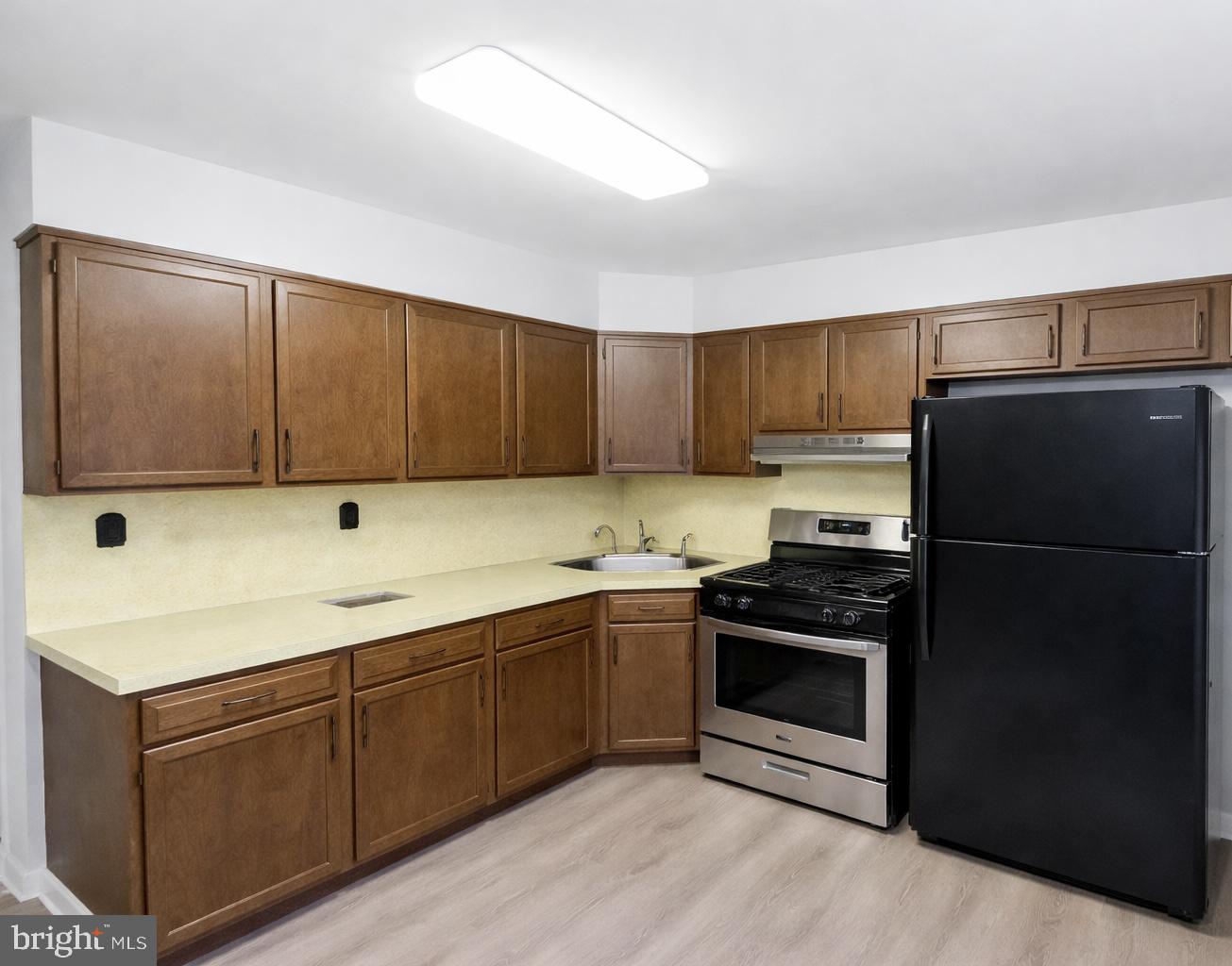 4564 Bermuda Street Philadelphia, PA 19124 - Photo 5 of 8 a kitchen with stainless steel appliances granite countertop a refrigerator stove and sink
