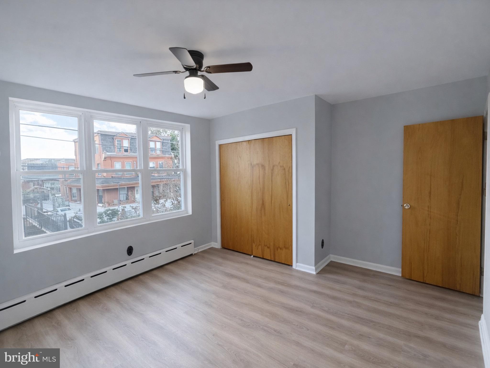 4564 Bermuda Street Philadelphia, PA 19124 - Photo 7 of 8 a view of an empty room with wooden floor and a window