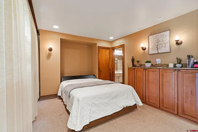 a bedroom with a bed and a lamp