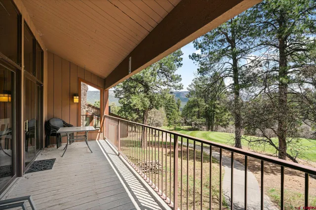 a view of balcony with chairs and wooden fence