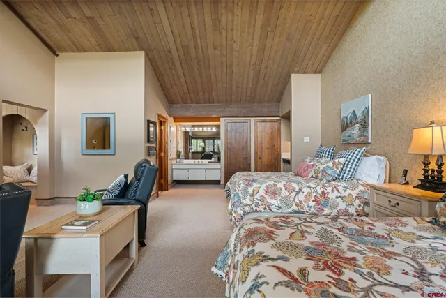 a bedroom with furniture and a wooden floor