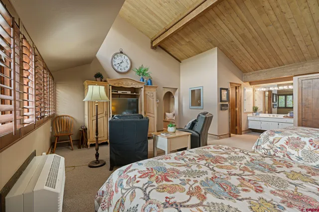 a bedroom with furniture and a clock