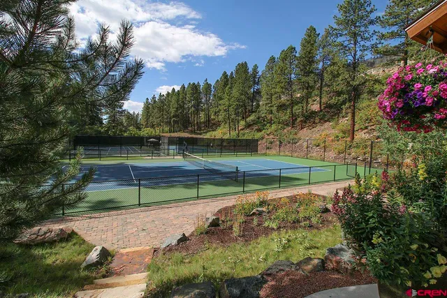 a swimming pool with trees in the background