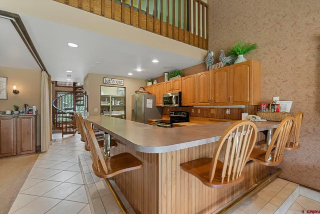 a view of kitchen with furniture and a refrigerator