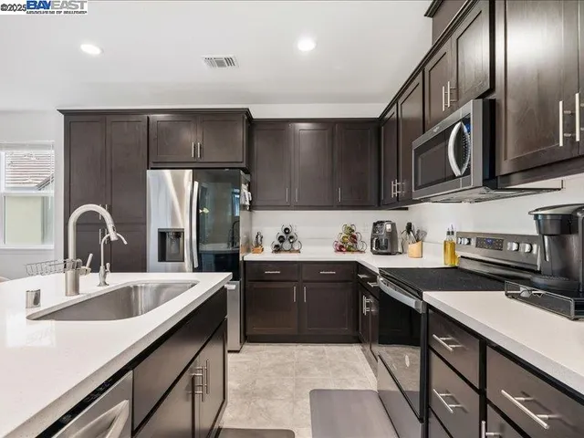a view of living room and kitchen island with furniture