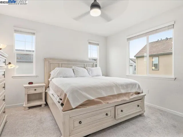 a bedroom with a bed and cabinet