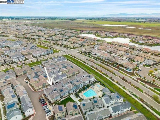 an aerial view of a tennis ground and a ocean view