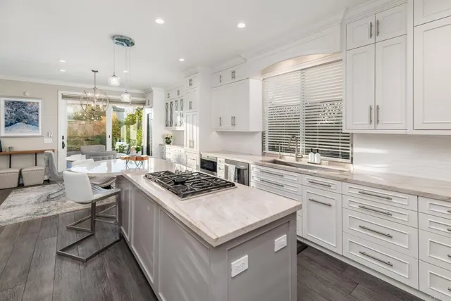 a kitchen with granite countertop a sink stove and cabinets